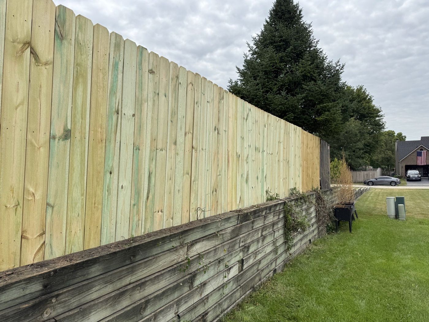 New fence set on retaining wall